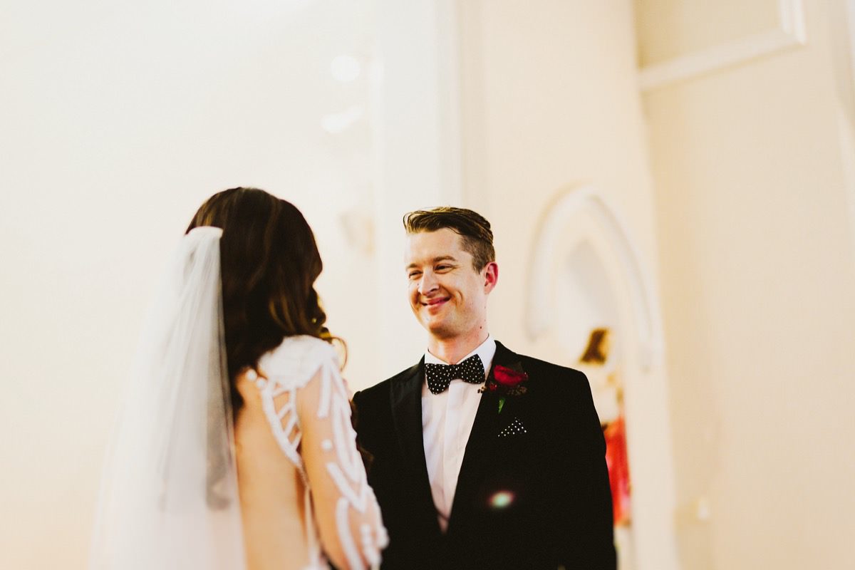 groom smiling at new bride 